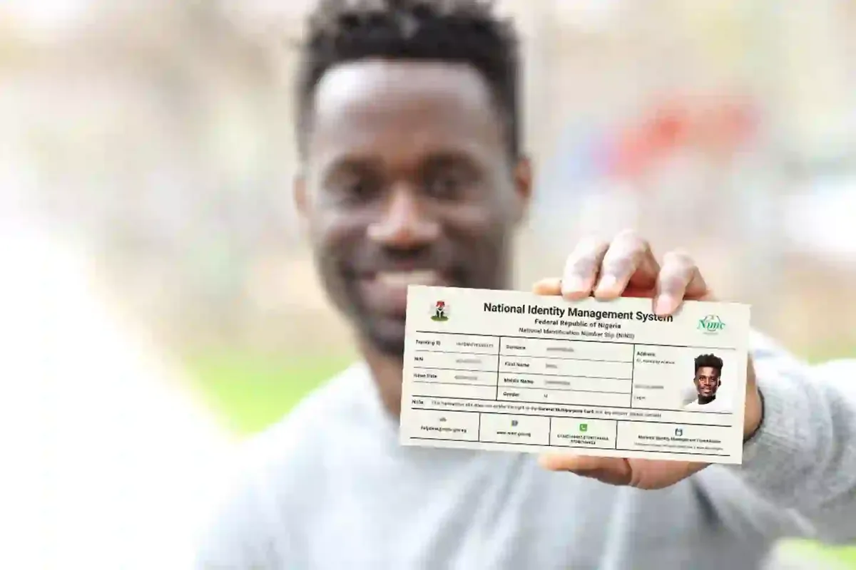 Man holding a National Identification Number (NIN) slip from the National Identity Management System